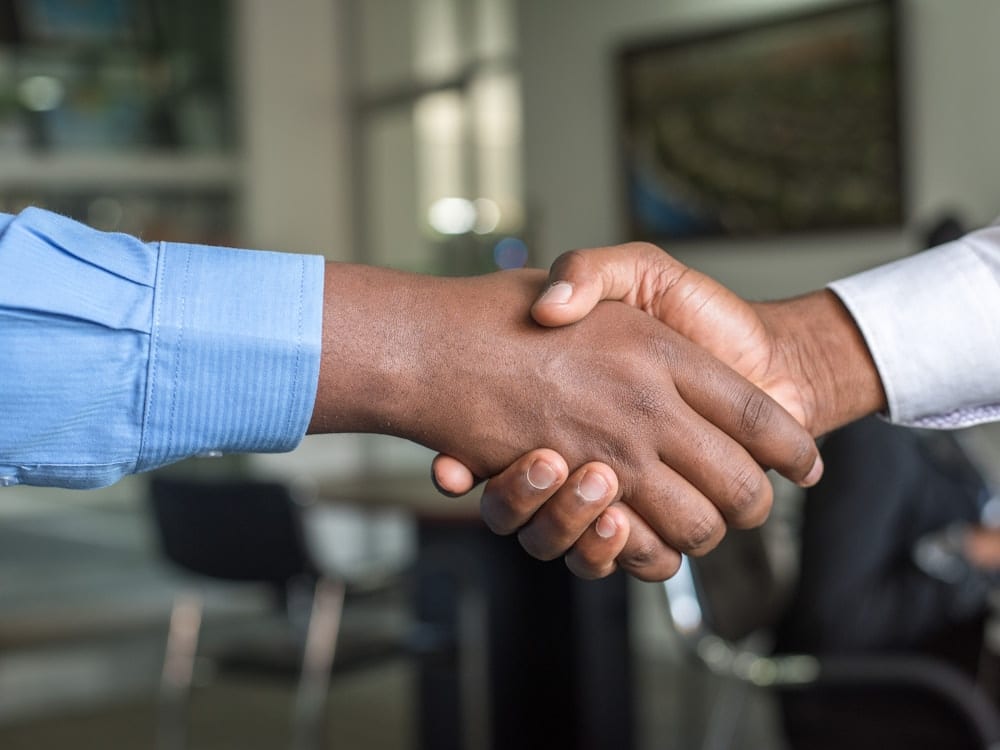 Partnership handshake representing affiliate recruitment